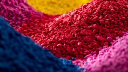 A vibrant pile of colorful powder in various hues, showcasing a spectrum of colors in a small mound.