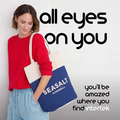 A woman carrying a Seasalt Cornwall-branded tote bag