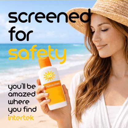 A woman holding a bottle of sunscreen on the beach