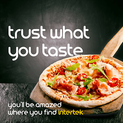 A freshly-cooked pizza on a serving paddle